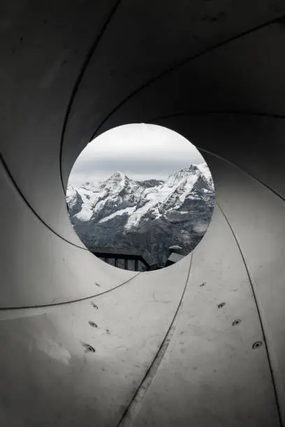 view of the swiss alps through a gun barrel
