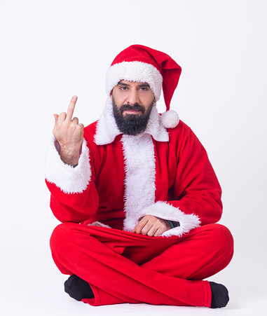 Angry looking santa claus making middle finger fuck sign