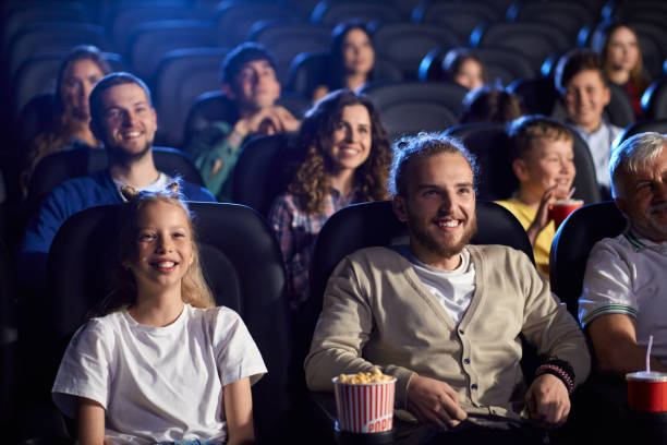 istock Young man with younger sister in cinema. 1292422053