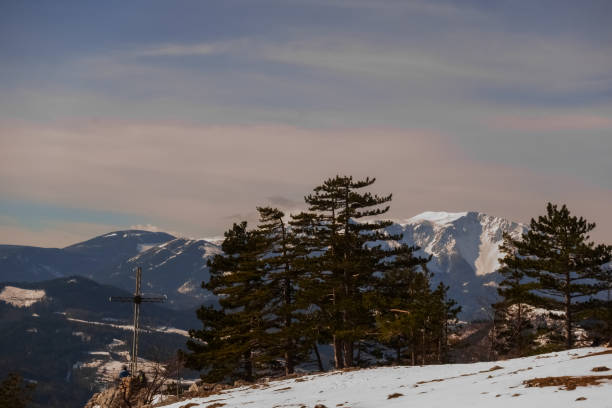istock summit cross and pinetrees with snow while hiking in the mountains 1292423461