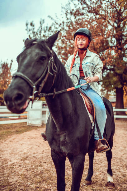 istock Female Trying Horse Riding On Ranch For The First Time 1292423699