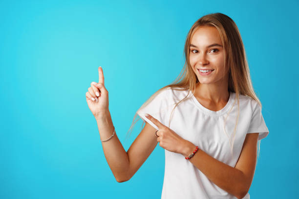 istock Portrait charming pretty cheerful girl showing copy space 1292423807