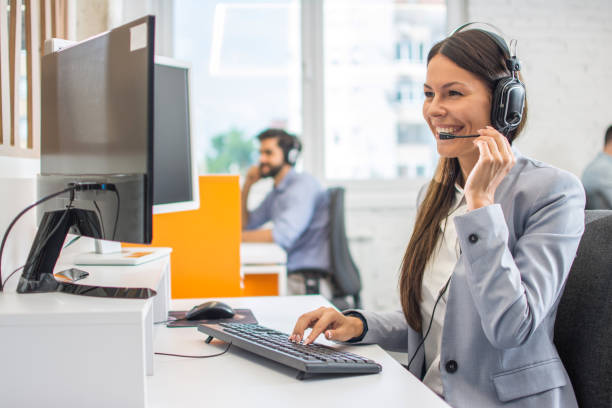 istock Portrait of happy smiling female customer support phone operator at workplace. 1292424051