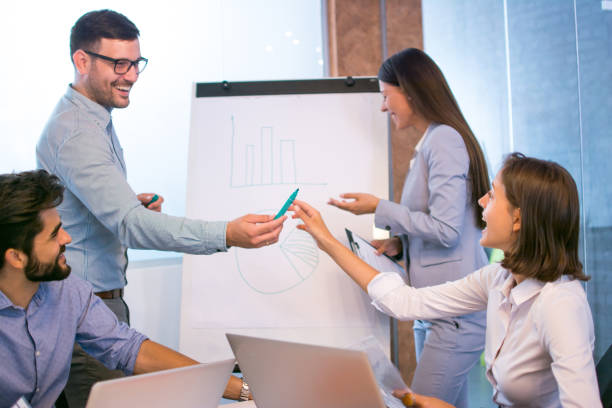 businessman giving presentation to his colleagues in the boardroom office. - flowchart marketing diagram women imagens e fotografias de stock