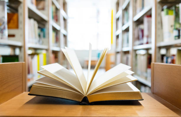 istock Open book on the desk of library 1292425834