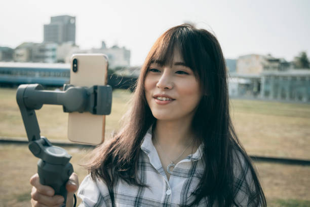 istock Asian woman using steady cam with smartphone 1292426166