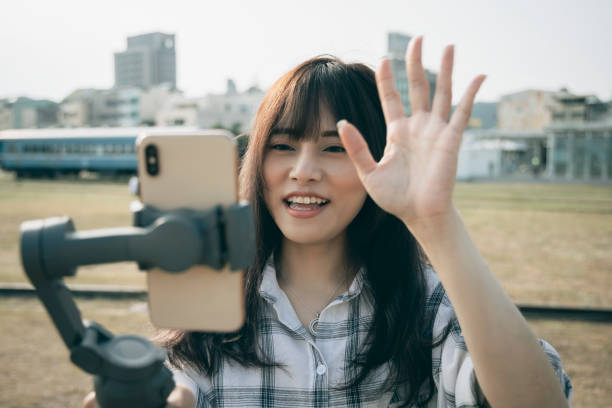 istock Asian woman using steady cam with smartphone 1292426177
