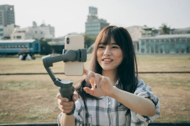 istock Asian woman using steady cam with smartphone 1292426205