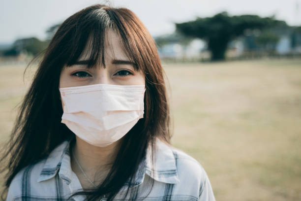 istock Asian woman wearing a mask 1292426813