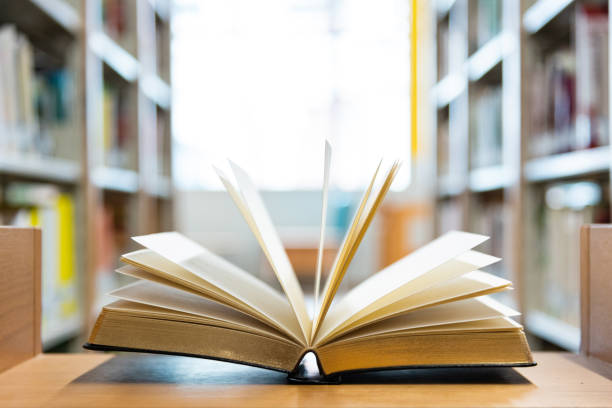 istock Open book on the desk of library 1292426869