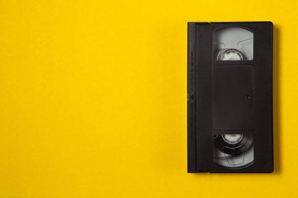 istock Video cassette videotape on a yellow background. Top view. 1292426885