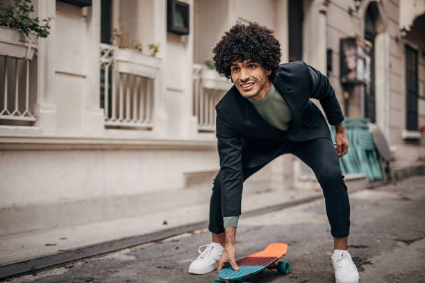 istock Cheeful businessman skateboarding to his workplace 1292432823