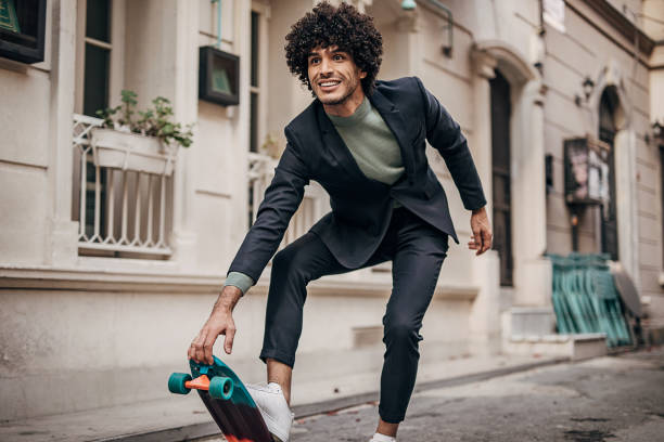 One cheeful businessman skateboarding to his workplace