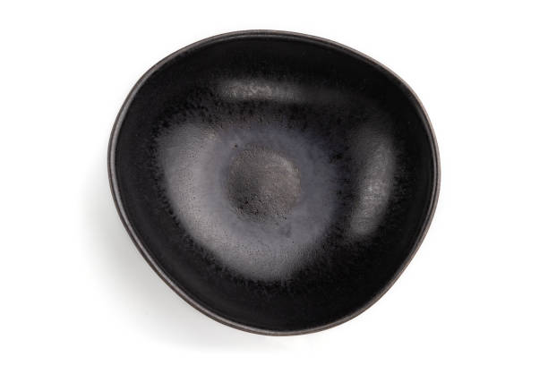 istock Empty black ceramic bowl isolated on white background. Top view, flat lay, close up. 1292433119