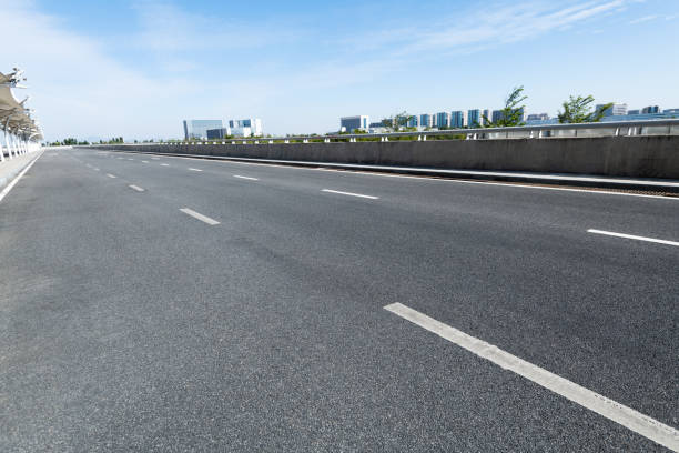 istock Empty asphalt road with buildings in the city 1292433208