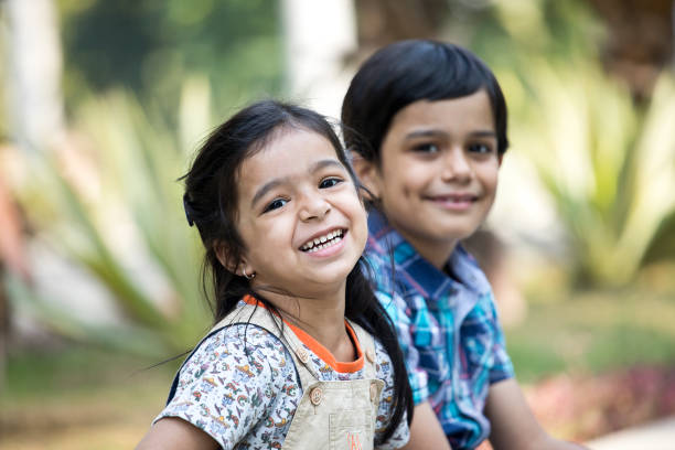 istock Happy brother and sister at park 1292434834