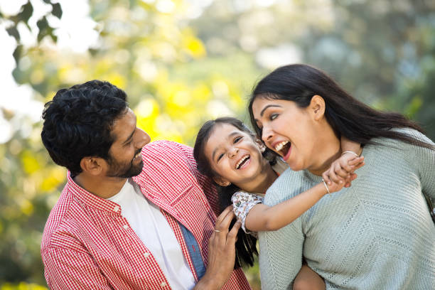 istock Parents with daughter having fun at the park 1292435477