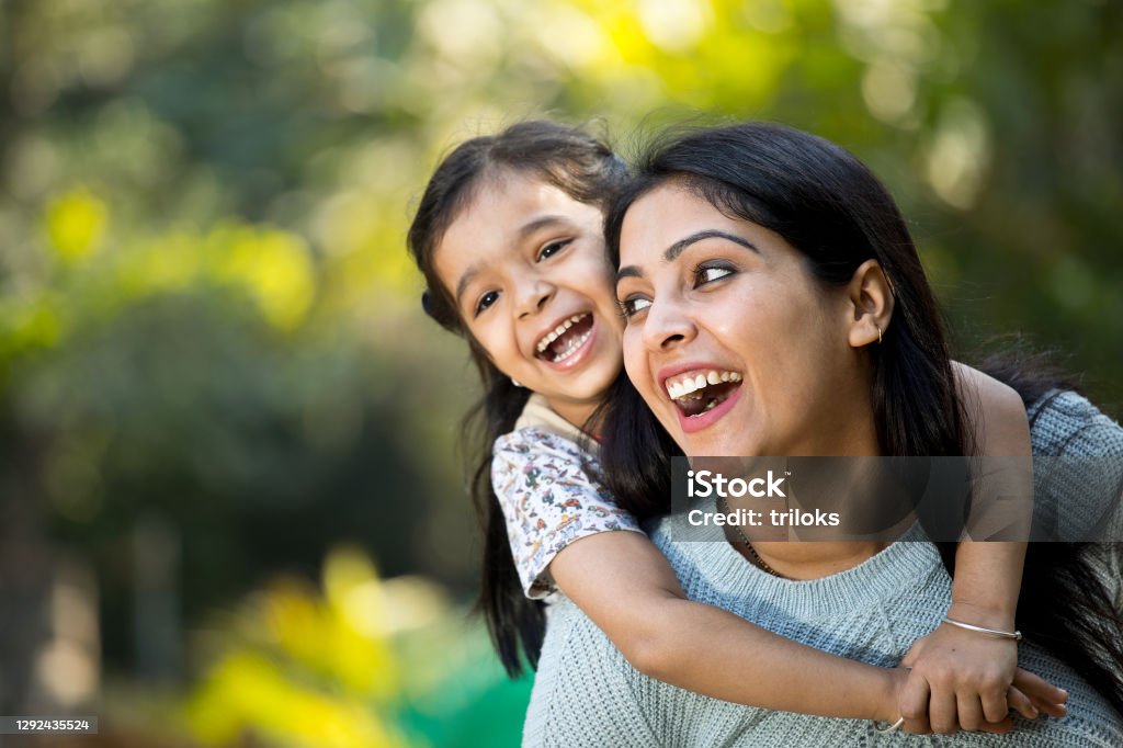 Mother and daughter having fun at the park Loving mother and daughter spending leisure time at park Child Stock Photo