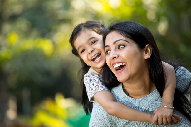 Mother and daughter having fun at the park Loving mother and daughter spending leisure time at park Indian Ethnicity stock pictures, royalty-free photos & images