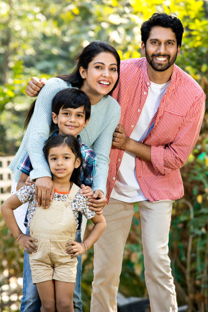 istock Happy Indian family having fun at park 1292435562