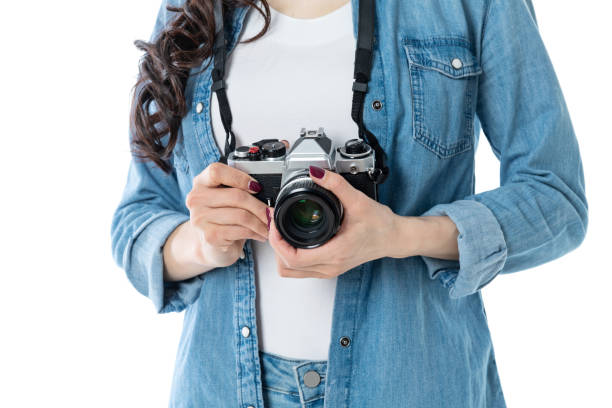 istock Woman hand holding a SLR camera on white background 1292435657