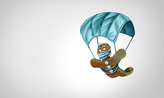 Gingerbread man with a face mask concept as a winter holiday season symbol for health and healthcare disease prevention as medical equipment parachute preventing a virus with 3D illustration elements.