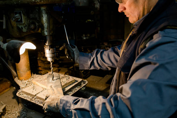 istock person operates a metal / drill - Close up 1292435755