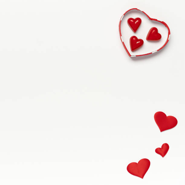 istock Saint Valentine concept, top view of colored hearts and candy inside gift box on white isolated with place for text background 1292436394
