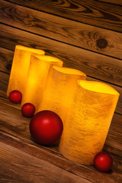 istock LED wax candles against wooden background 1292436422