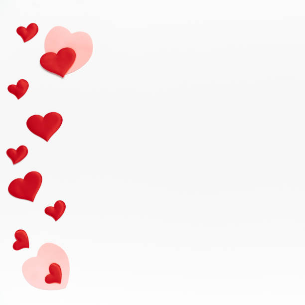 istock Flat lay, top view. Many little colored hearts on white isolated background. Template of Valentine day with place for text 1292436465