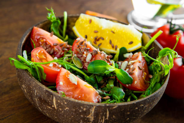 Healthy microgreen salad with tomatoes and seeds close-up. High quality photo