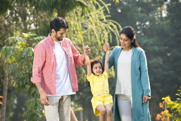 istock Happy family playing at park 1292438462