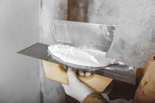 istock Plasterer with trowel and putty knife 1292439003