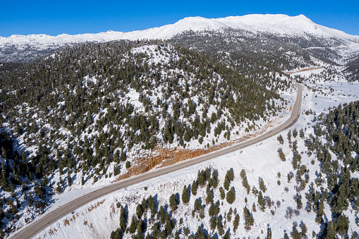 An aerial view of a snowy road during winter. Taken via drone. Antalya, Turkey