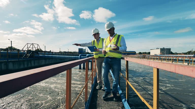 Wastewater operators examining water samples at a wastewater cleaning facility