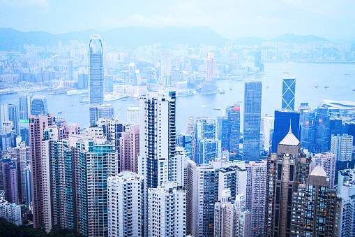 Hong Kong, August 2018. Top View of Hong Kong City Skyscrapers and Victoria Harbour from The Peak.