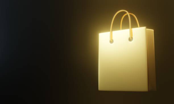 istock Empty gold color shopping bag on the black background 1292443574