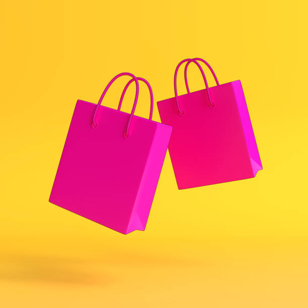 istock Flying empty  shopping bags on the yellow background 1292443616