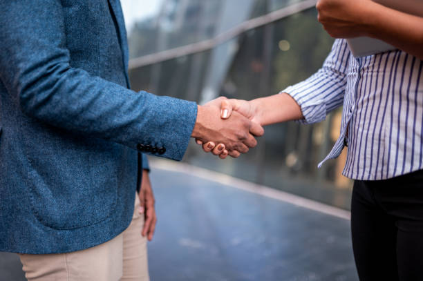 istock Cropped shot of two unrecognizable businesspeople shaking hands 1292445038