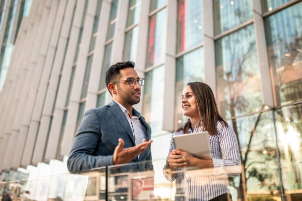 istock Two colleagues in front of an office building 1292445544