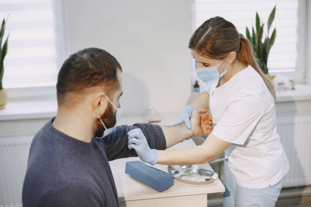 istock Nurse taking blood sample from patient at the doctors office 1292445881