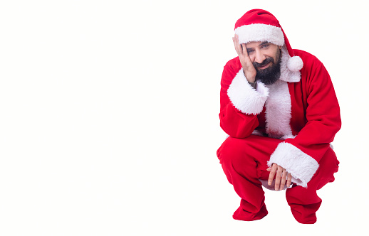 Merry santa claus sitting on the ground.