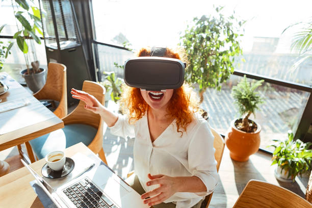 istock Curly redhead woman using vr glasses having fun 1292450865