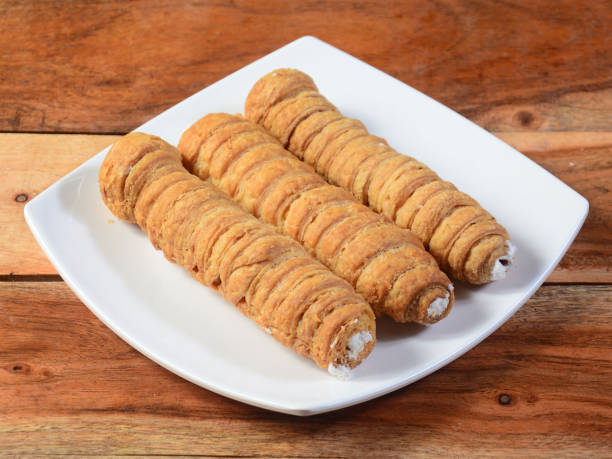 istock Sweet Bakery Food Puff Roll with Cream also know as Cream Roll, puff pastry is a type of sponge cake roll filled with vanilla cream, 1292451584