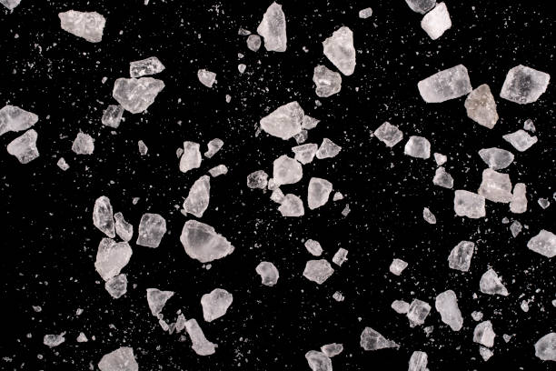 istock Large and small crystals of rock salt on a black background. 1292452659
