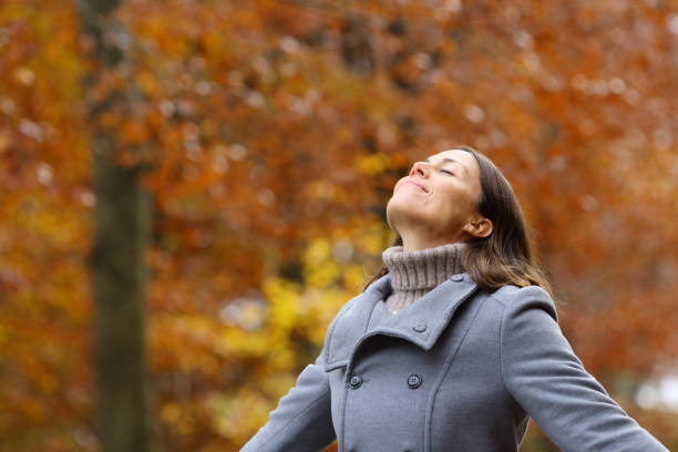 istock Middle age female breathing fresh air in a forest in fall 1292453716