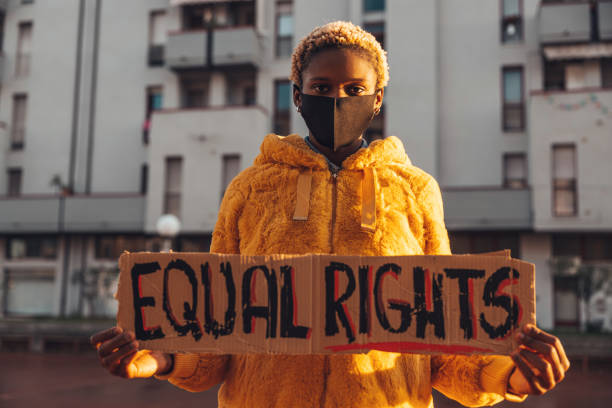 Activist for equal rights Young woman holding a message written on a cardboard black civil rights stock pictures, royalty-free photos & images
