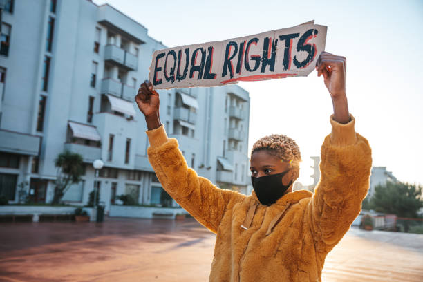 Activist for equal rights Young woman holding a message written on a cardboard racial equality stock pictures, royalty-free photos & images