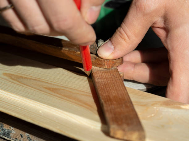 istock the man draws a line with a pencil on the construction Board measuring the desired angle 1292458337