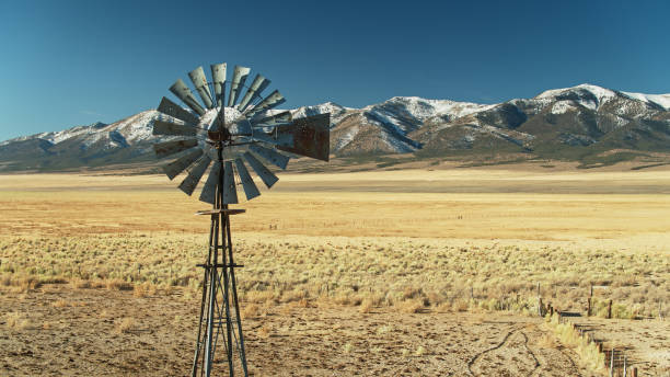 istock Drone Shot of Rusty Old Windpump Riddled with Bullet Holes 1292458556
